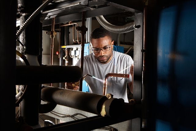 Man brazing a pipe